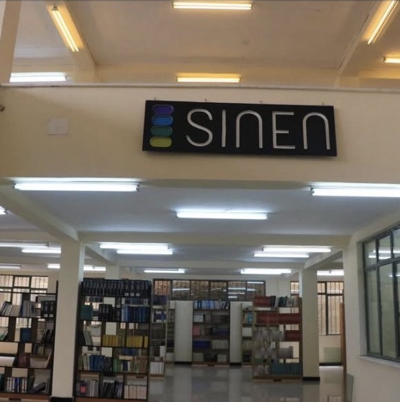 The Sinen sign above rows of bookshelves inside the Lafto library